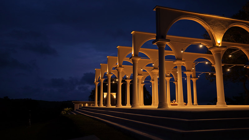 Lit arches and columns against the night sky